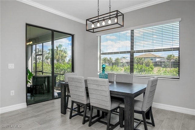 dining room with baseboards and ornamental molding