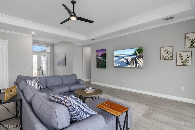 living room with visible vents, baseboards, crown molding, and french doors