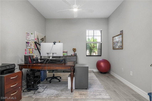 office space with baseboards and a ceiling fan