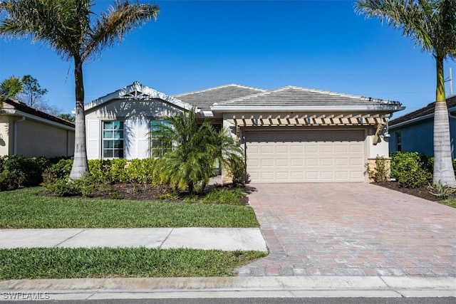 ranch-style house with a tiled roof, stucco siding, driveway, and a garage