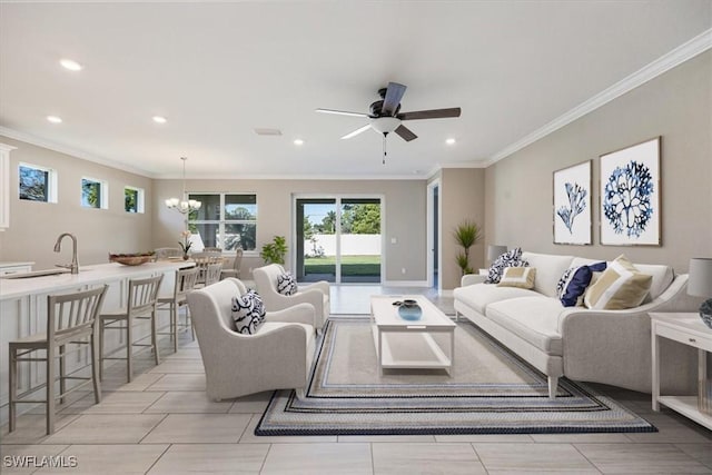 living area featuring recessed lighting, ceiling fan with notable chandelier, and crown molding