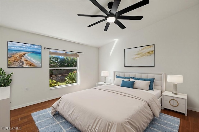 bedroom with vaulted ceiling, a ceiling fan, baseboards, and wood finished floors