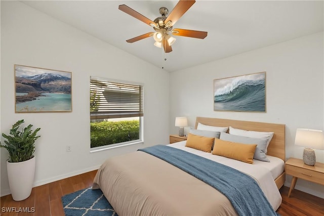 bedroom featuring baseboards, a ceiling fan, lofted ceiling, and wood finished floors