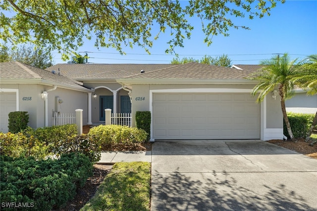 ranch-style house with stucco siding, driveway, a shingled roof, and a garage