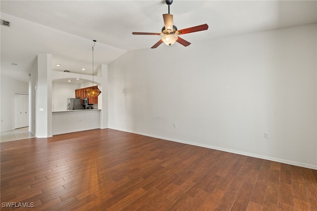 unfurnished living room with a ceiling fan, lofted ceiling, recessed lighting, and wood finished floors