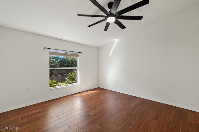 spare room featuring ceiling fan, baseboards, and wood finished floors