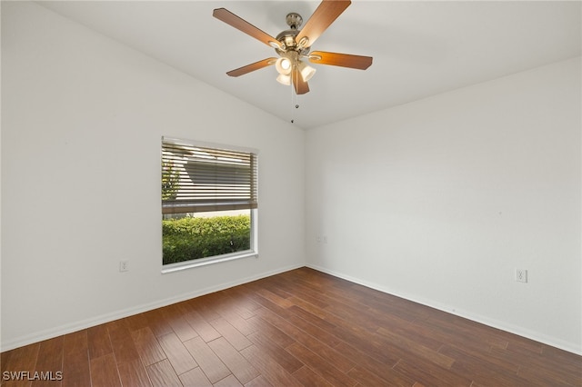 spare room with dark wood finished floors, baseboards, lofted ceiling, and a ceiling fan