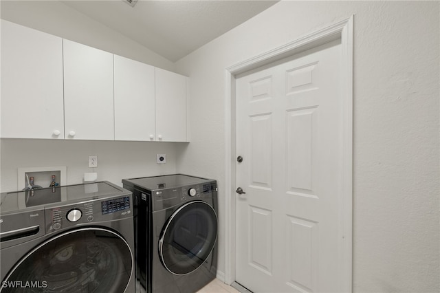 laundry area with cabinet space and washer and clothes dryer