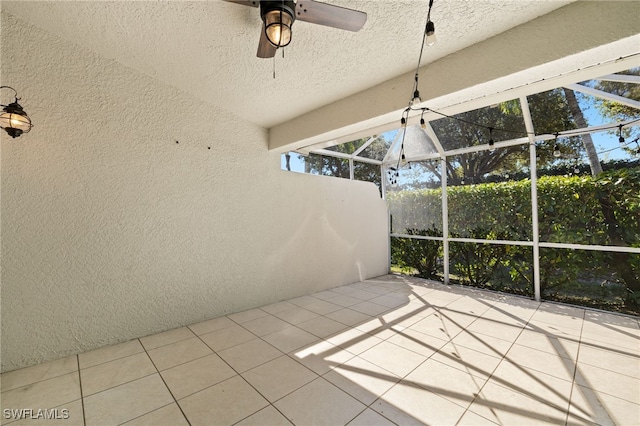 unfurnished sunroom featuring ceiling fan