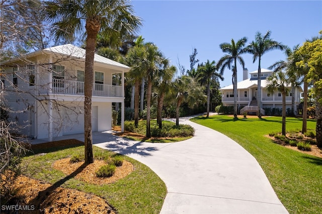 surrounding community featuring a yard and driveway