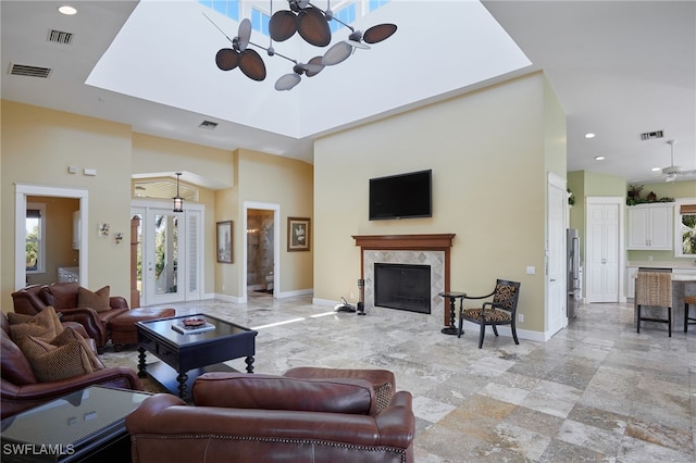 living room with baseboards, visible vents, and a premium fireplace