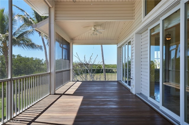 unfurnished sunroom with a ceiling fan