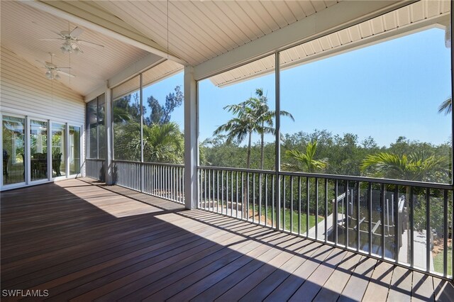 unfurnished sunroom with vaulted ceiling and ceiling fan