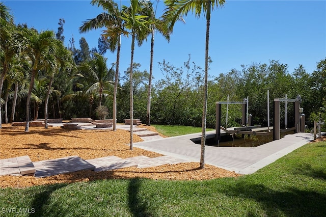 exterior space with a yard, boat lift, and a dock