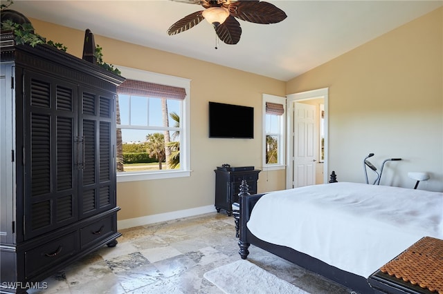 bedroom with baseboards, ceiling fan, and vaulted ceiling