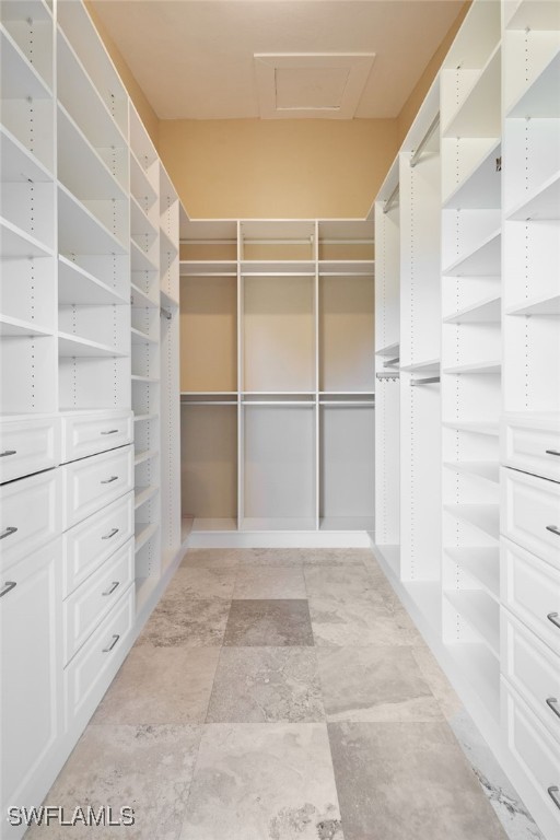 spacious closet featuring attic access