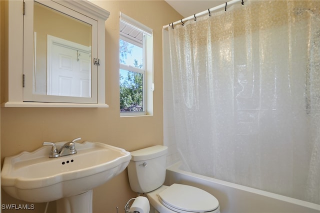 bathroom with a sink, toilet, and shower / bathtub combination with curtain