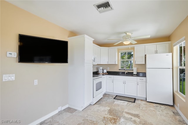 kitchen featuring white cabinetry, white appliances, visible vents, and a sink