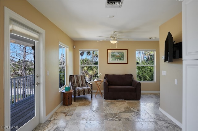 sitting room featuring visible vents, baseboards, and a healthy amount of sunlight