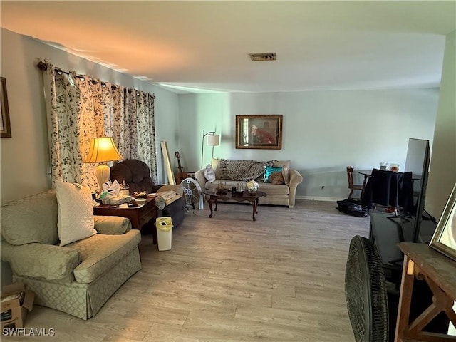 living room with light wood-type flooring and visible vents