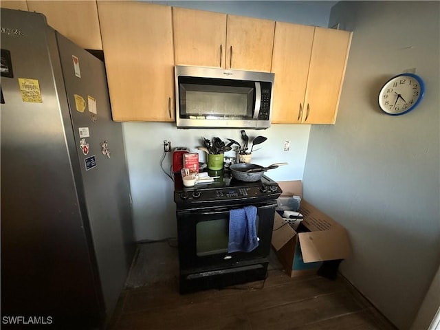 kitchen featuring appliances with stainless steel finishes and wood finished floors