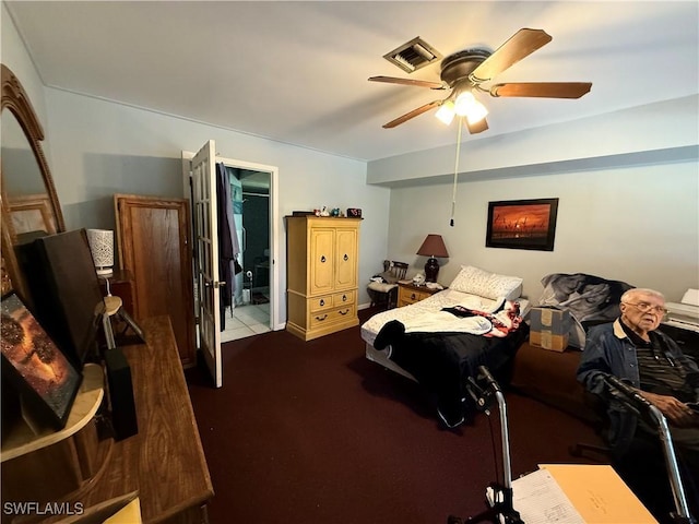 bedroom with visible vents, ceiling fan, and dark colored carpet