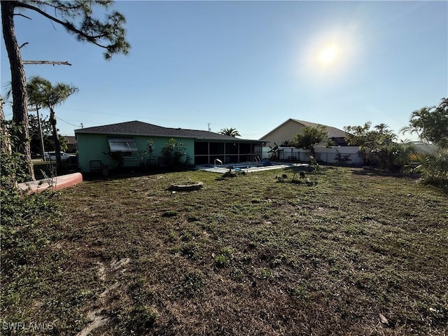 view of yard featuring a sunroom and fence