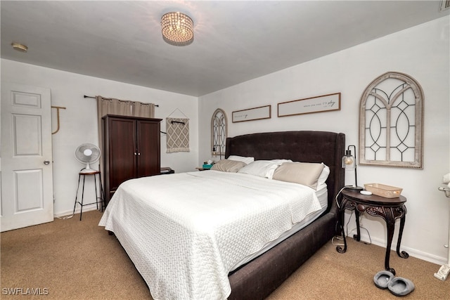 bedroom featuring carpet and baseboards