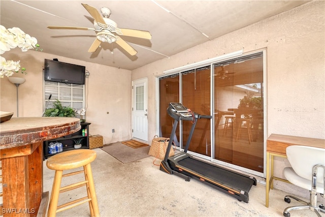 workout room with a ceiling fan