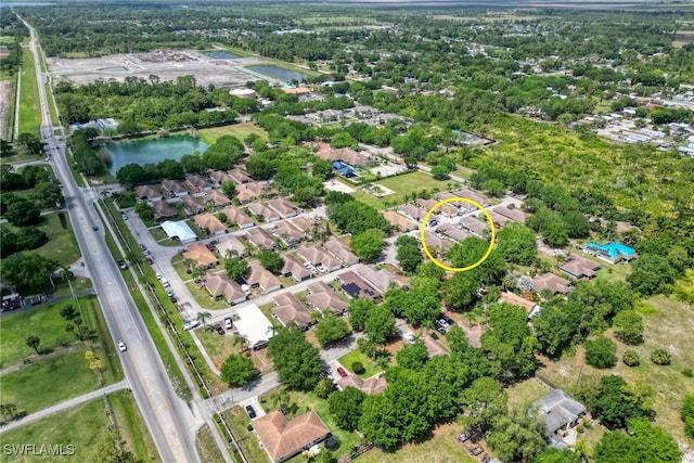 drone / aerial view with a residential view and a water view