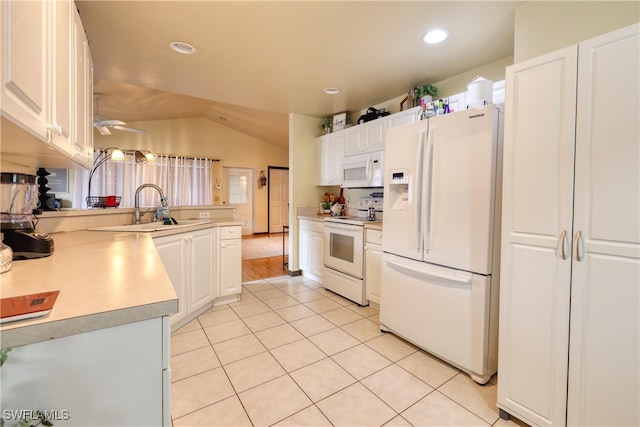 kitchen featuring white appliances, light tile patterned floors, a peninsula, a sink, and light countertops