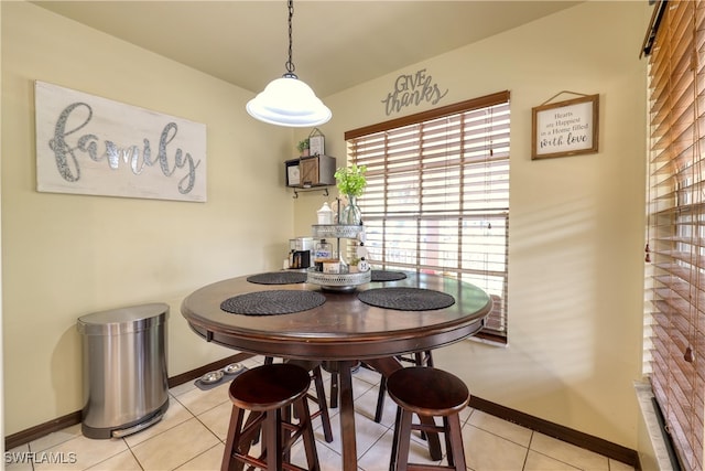 dining room with light tile patterned floors and baseboards