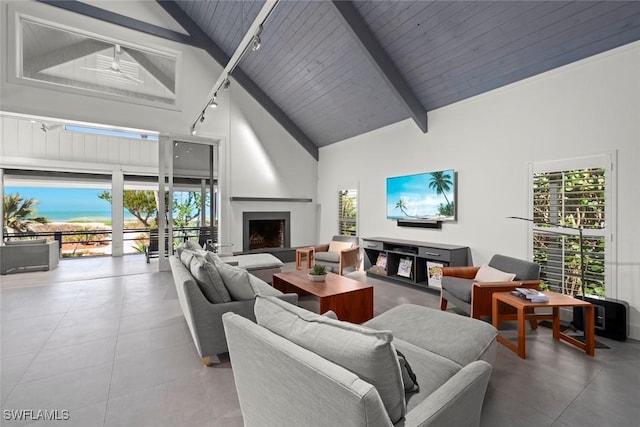 16886 Captiva Dr, Captiva, FL 33924 - tiled living area with high vaulted ceiling, wooden ceiling, a fireplace, rail lighting, and beamed ceiling