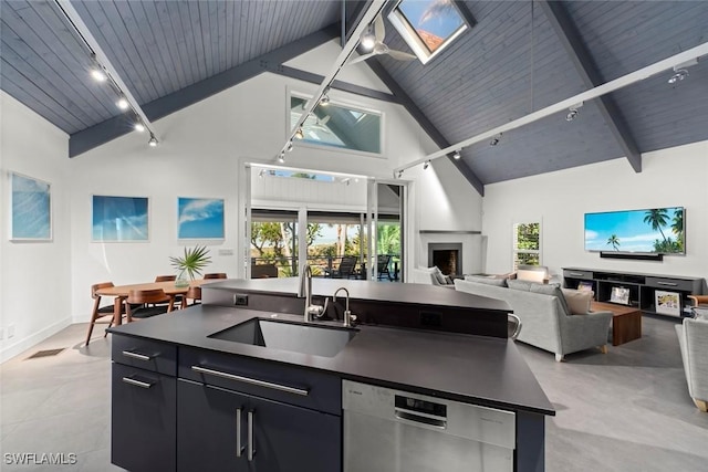 16886 Captiva Dr, Captiva, FL 33924 - kitchen featuring stainless steel dishwasher, open floor plan, a sink, and a healthy amount of sunlight