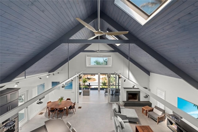 16886 Captiva Dr, Captiva, FL 33924 - unfurnished living room featuring high vaulted ceiling, a skylight, beamed ceiling, ceiling fan, and wooden ceiling