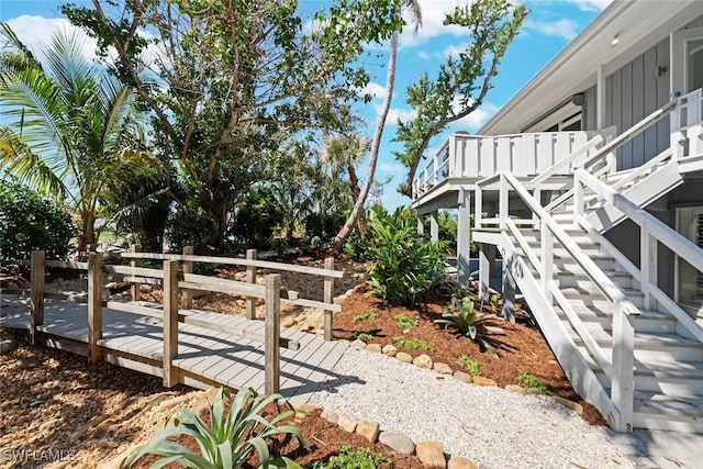 16886 Captiva Dr, Captiva, FL 33924 - view of yard featuring stairs and a wooden deck