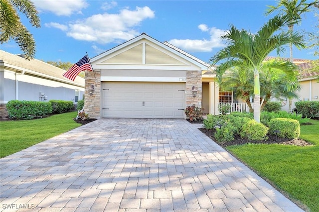 single story home featuring decorative driveway, stone siding, a garage, and a front lawn