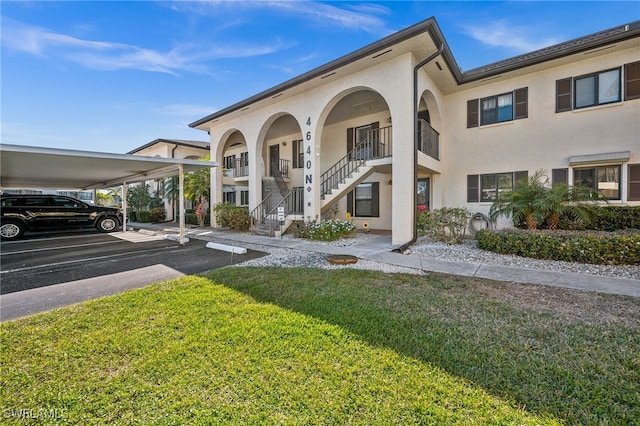 view of property featuring covered parking