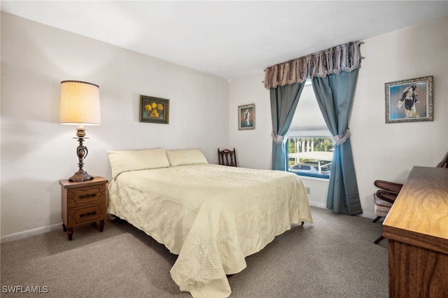 bedroom featuring carpet and baseboards