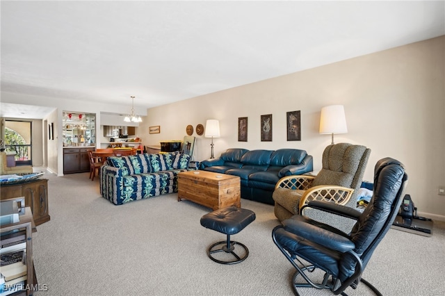 carpeted living room featuring a chandelier and baseboards