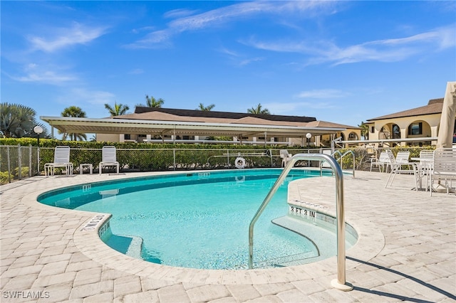 pool featuring a patio and fence