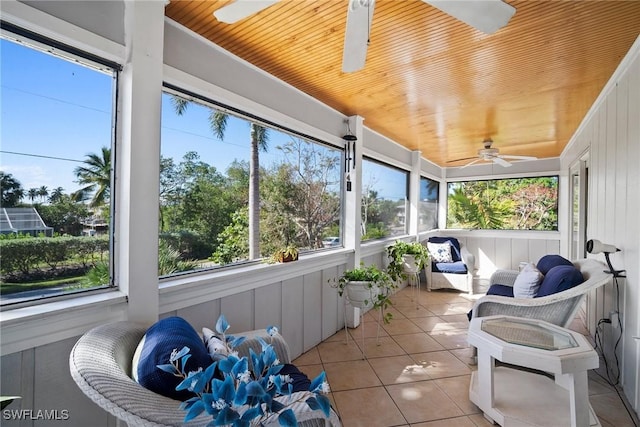 sunroom / solarium with wood ceiling and ceiling fan