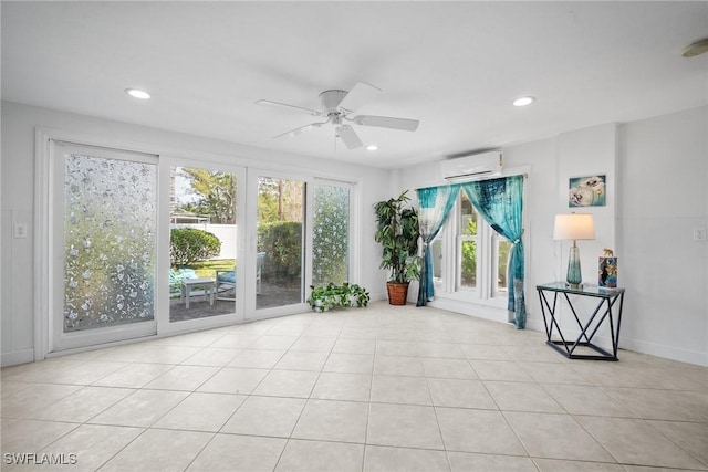 unfurnished sunroom with an AC wall unit and ceiling fan