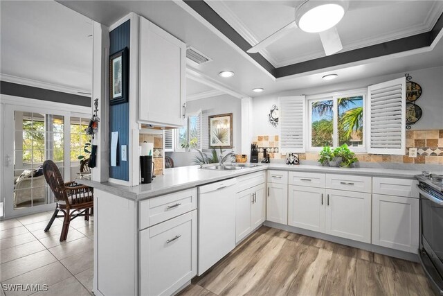 kitchen featuring a sink, dishwasher, ornamental molding, and white cabinetry