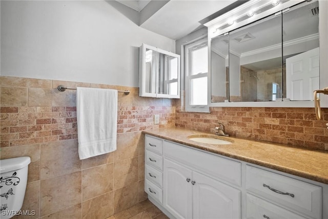 full bath featuring a wainscoted wall, toilet, tile walls, a shower, and vanity