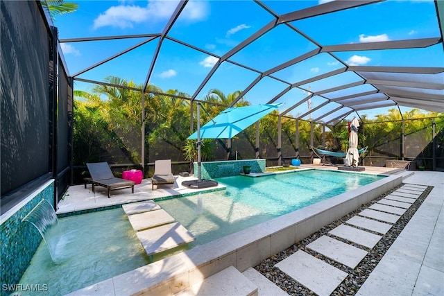 outdoor pool with a patio area and glass enclosure