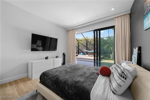 bedroom with baseboards, light wood-style floors, and access to exterior