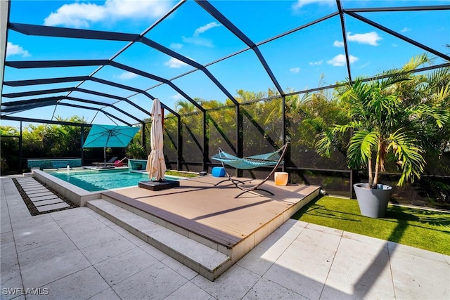 outdoor pool with glass enclosure, a yard, and a patio area