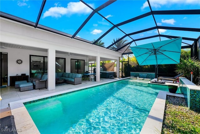 outdoor pool with ceiling fan, a lanai, outdoor lounge area, a patio area, and a jacuzzi