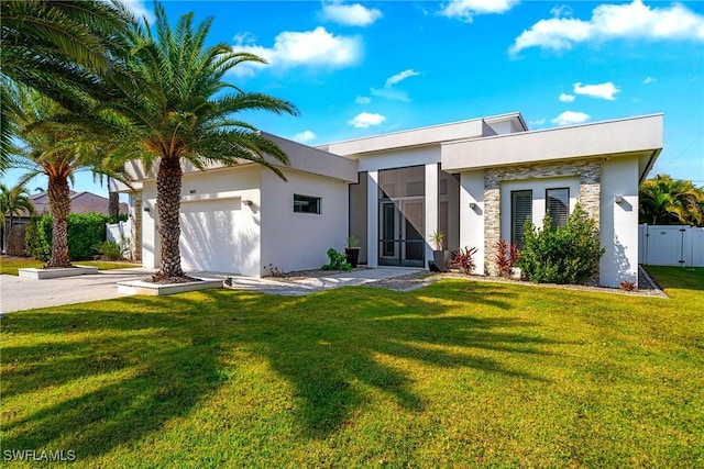 contemporary home featuring stucco siding, a front lawn, stone siding, concrete driveway, and a garage